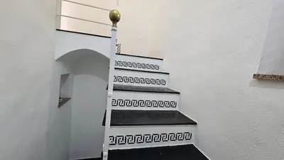 a staircase in a white wall with a stair case at 