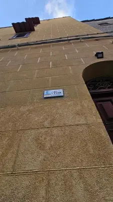 a sign sitting on the side of a building at 