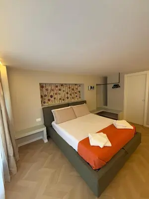 a bedroom with a bed with two towels on it at Vivimi Deluxe Apartment in Palermo