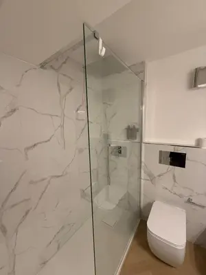 a bathroom with a glass shower with a toilet at Vivimi Deluxe Apartment in Palermo