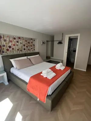 a bedroom with a large bed with towels on it at Vivimi Deluxe Apartment in Palermo