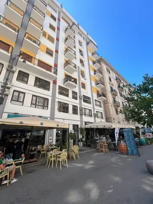 a large building with tables and chairs in front of it at Vivimi Deluxe Apartment in Palermo
