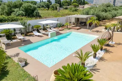 an overhead view of a pool with chairs and umbrellas at 14th Oasis Family Room In Villa With Pool Near Palermo in Carini