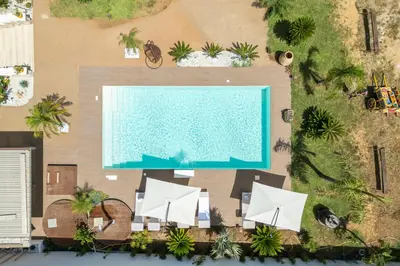 an overhead view of a swimming pool with white umbrellas at 14th Oasis Villa With Private Pool Near Palermo in Carini