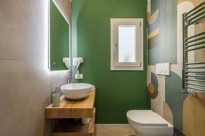 a green bathroom with a sink and a toilet at 14th Oasis Villa With Private Pool Near Palermo in Carini