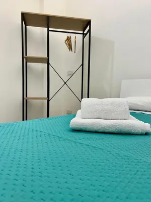a bedroom with a bed with a green mattress at Leonetti Due in Carini