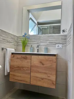 a bathroom with a sink and a mirror at Leonetti Due in Carini
