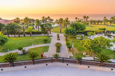 a view of the park from the balcony of a resort at Grand Palladium Sicilia Resort & Spa in Campofelice di Roccella