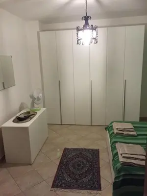 a bedroom with white cabinets and a chandelier at Dall'Orso Grigio in Balestrate