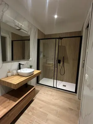a bathroom with a sink and a shower at Beta Suite in Palermo