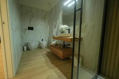 a bathroom with a sink and a mirror at Beta Suite in Palermo