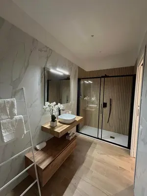 a bathroom with a sink and a shower at Beta Suite in Palermo