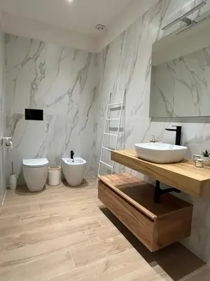 a bathroom with two sinks and a mirror at Beta Suite in Palermo