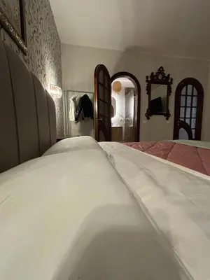a bathroom with a sink and a toilet and a mirror at Grand Holiday Home Namarì in Palermo