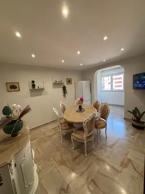 a kitchen and dining room with a table and chairs at Grand Holiday Home Namarì in Palermo