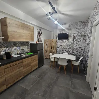 a kitchen with a table and chairs in a room at Hakuna matata in Terrasini
