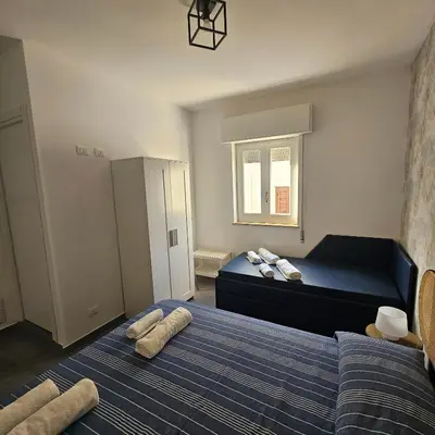 a bedroom with a blue bed with pillows on it at Hakuna matata in Terrasini