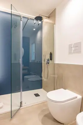 a bathroom with a glass shower and a toilet at Capo D'Amuri in Palermo