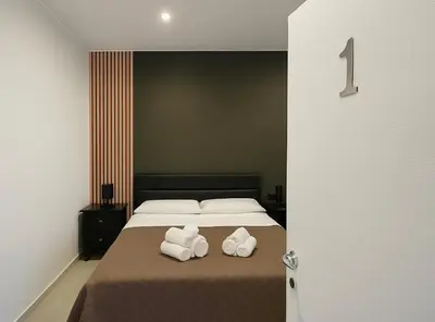 a bedroom with a bed with two towels on it at Rooms, eleganza moderna nel centro storico di Palermo in Palermo