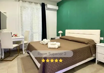 a bedroom with a room superintendent two beds and a desk at Rooms, eleganza moderna nel centro storico di Palermo in Palermo