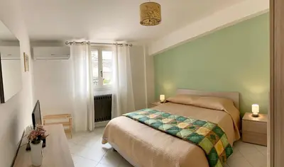 a bedroom with a bed and a window at Casetta in piazza in Palazzo Adriano