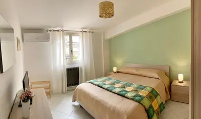 a bedroom with a bed and a window at Casetta in piazza in Palazzo Adriano