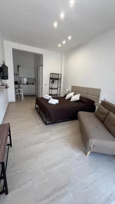 a large bedroom with a bed and a couch at Amuní Holiday House in Cinisi