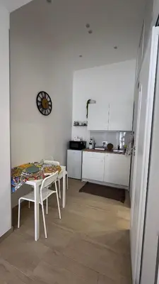 a kitchen with a table and a table and a table and a kitchen at Amuní Holiday House in Cinisi