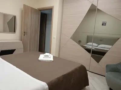 a hotel room with a bed and a mirror at La casa di Marió in Palermo