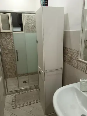 a small bathroom with a shower and a sink at La casa di Marió in Palermo