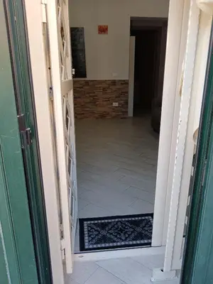an open door to a hallway with a tile floor at La casa di Marió in Palermo