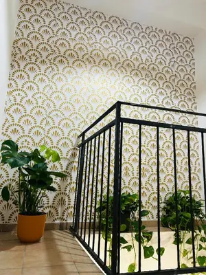 a room with a staircase with a white and white wallpaper at Mercede rooms Ballaró in Palermo