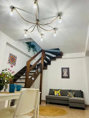 a living room with a staircase and a couch at Mercede rooms Ballaró in Palermo