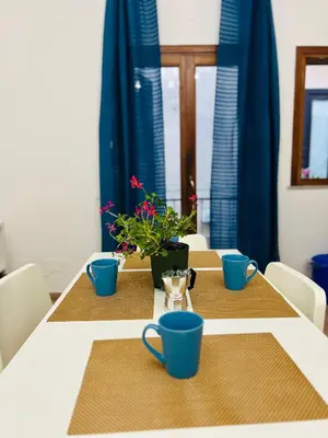 a table with blue cups and plants on it at Mercede rooms Ballaró in Palermo