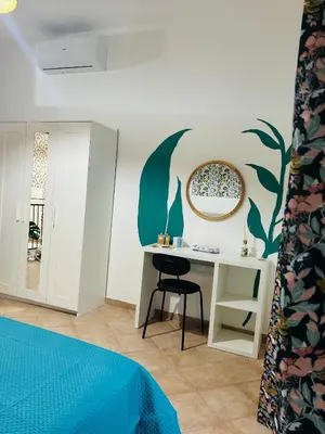 a bedroom with a desk and a bed and a table at Mercede rooms Ballaró in Palermo