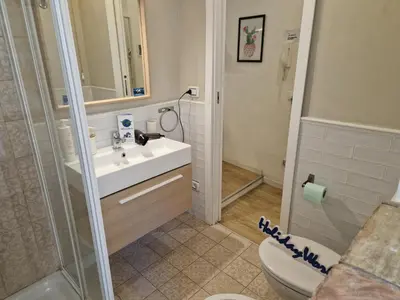 a bathroom with a toilet and a sink and a shower at Come a Casa by Holiday World in Palermo