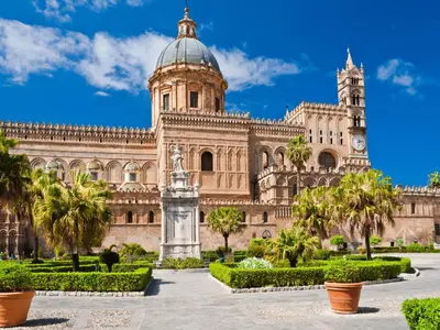 a large building with a statue in front of it at Come a Casa by Holiday World in Palermo