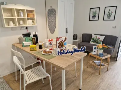 a living room with a table with food on it at Come a Casa by Holiday World in Palermo
