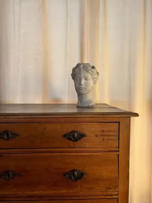 a statue of a head sitting on top of a dresser at La casetta dei limoni in Santa Flavia