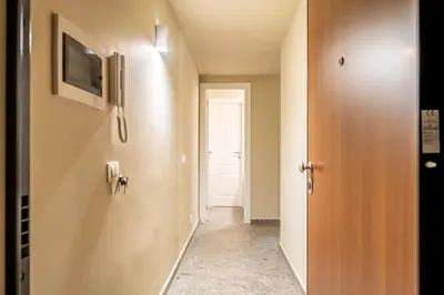 a hallway with a door and a television on a wall at Turrisi Apartment in Palermo