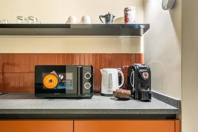 a kitchen counter with a toaster and a coffee maker at Turrisi Apartment in Palermo