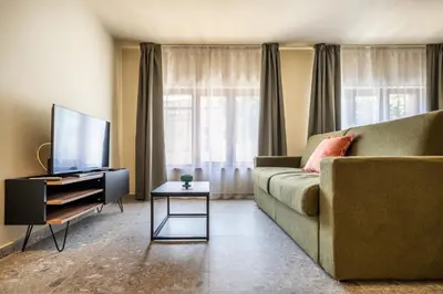 a living room with a couch and a tv at Turrisi Apartment in Palermo