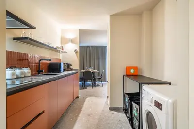 a kitchen with a washer and dryer at Turrisi Apartment in Palermo