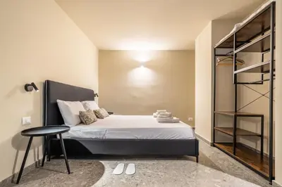a small bedroom with a bed and a table at Turrisi Apartment in Palermo