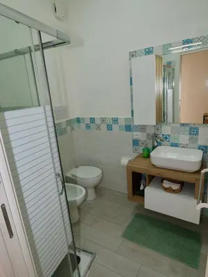 a bathroom with a toilet and a sink and a shower at Casetta al Duomo in Monreale