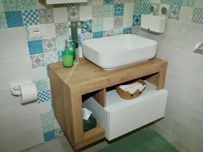 a bathroom with a sink on a wooden table at Casetta al Duomo in Monreale
