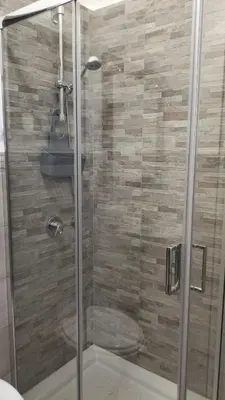 a glass shower with a toilet in a bathroom at Casa Verdi in Capaci