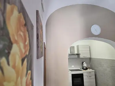 a kitchen with a clock on the wall and a sink at Casa Verdi in Capaci