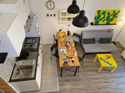 a kitchen with a table and a dining room at Il Fico d'India by Holiday World in Palermo