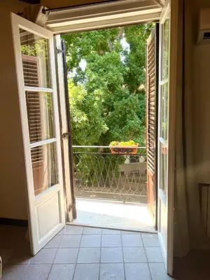 an open door with a view of a balcony at Mandarhouse Dante in Palermo